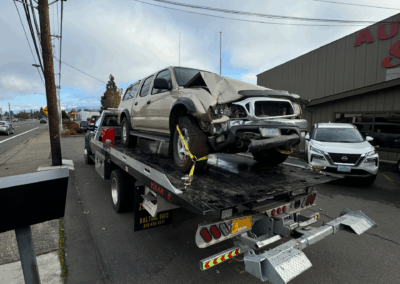Camel Towing tow truck with wrecked vehicle on the flatbed