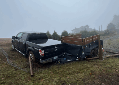 A stuck black truck with an attached trailer